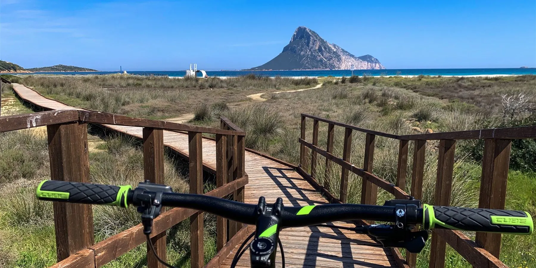 Bike ride on the boardwalk towards Tavolara island