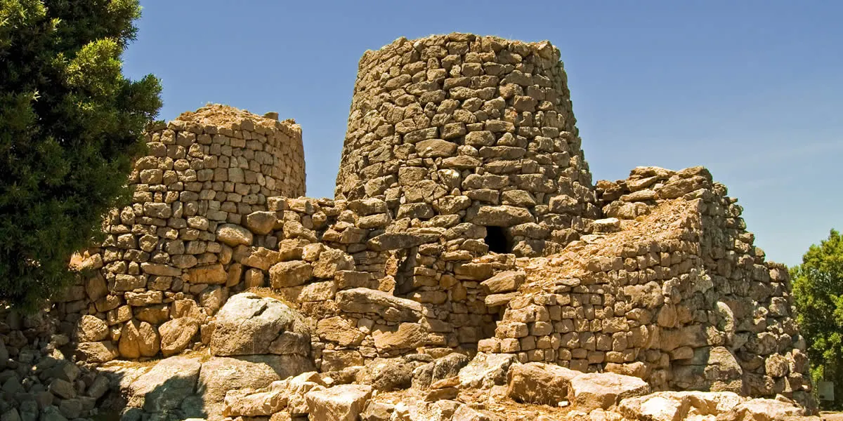 Stone towers of a nuraghe under the Sardinian sun