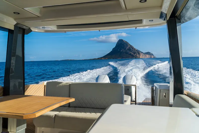View from the stern of the Saxdor boat, Tavolara island rising from the open sea