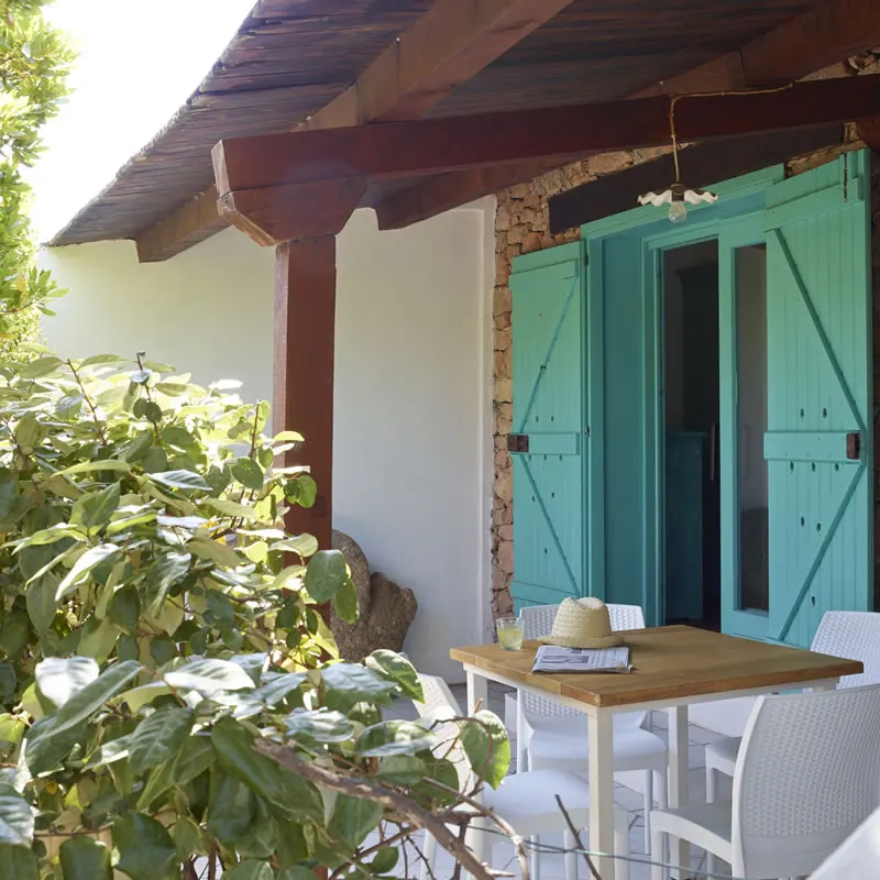 Pergola terrace of a two-room apartment with turquoise shutters