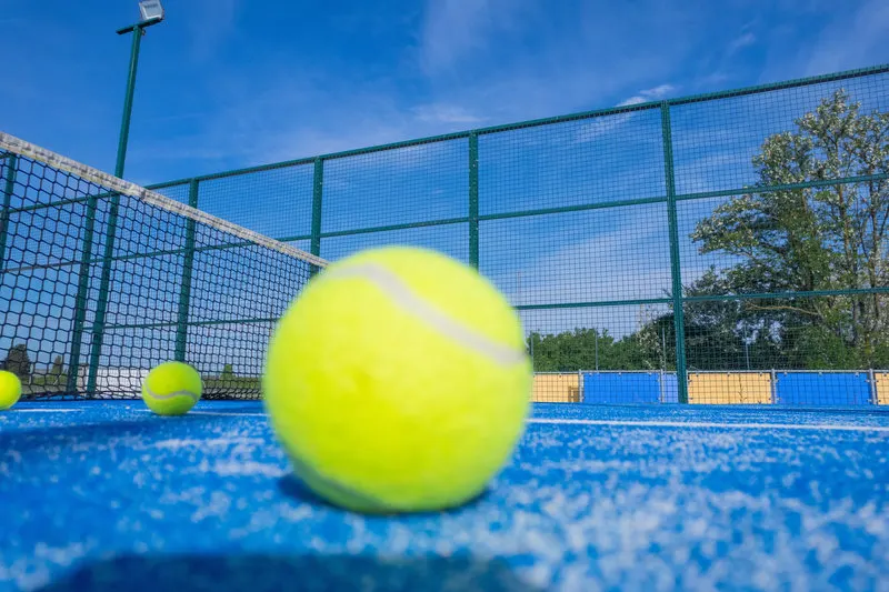 Ball on the blue padel court of the village