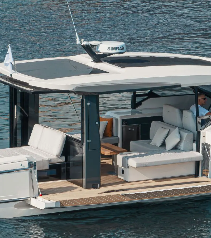 Open cockpit of the Saxdor 400 GTO yacht with white sofas and teak deck