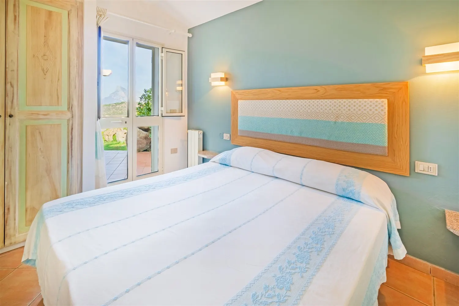 Bedroom of a villa with Sardinian textiles