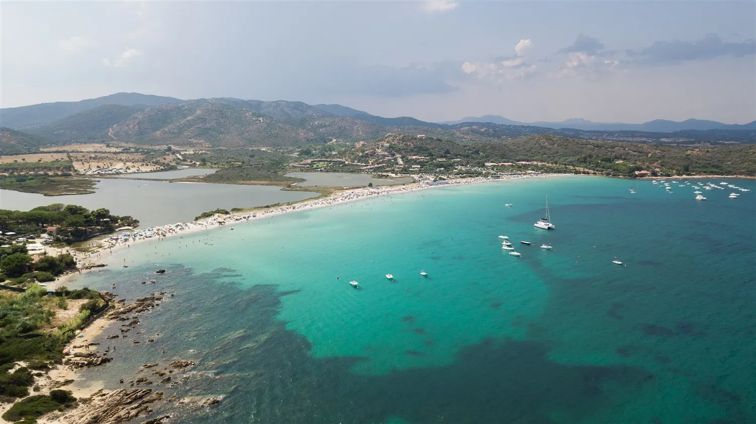 Umbrellas and clear turquoise water on Porto Taverna beach