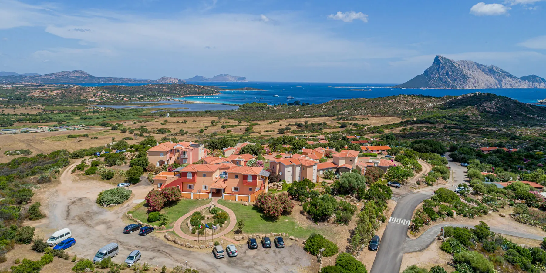 Aerial view of the village of Lu Nibareddu with Tavolara behind